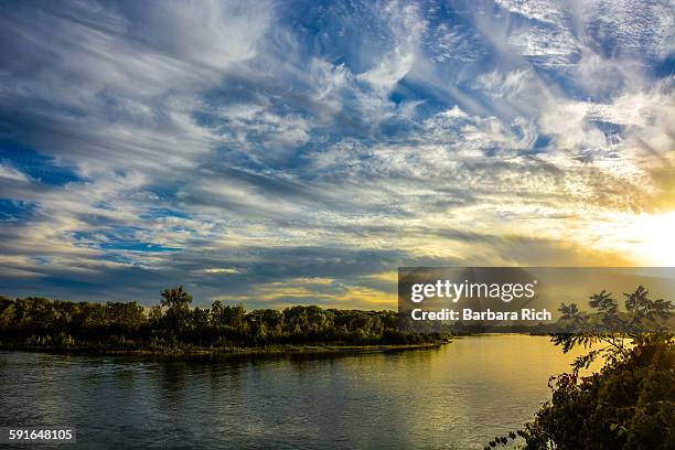 dramatic clouds in the sky on the sacramento river - chico stock pictures, royalty-free photos & images