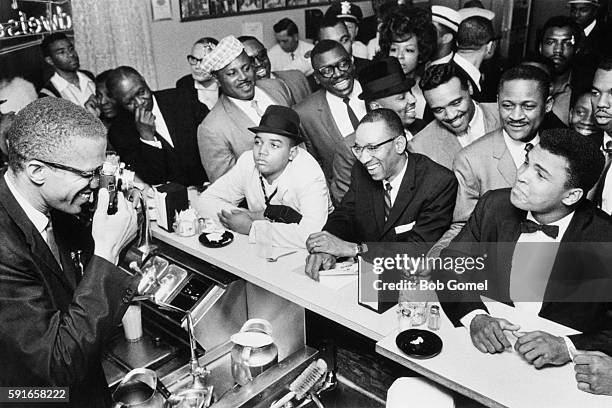 American boxer Muhammad Ali with African-American Muslim minister, public speaker, and human rights activist Malcolm X , after Ali beat Sonny Liston...