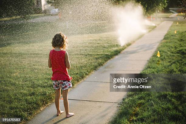 little girl and sprinklers - annie sprinkle stock pictures, royalty-free photos & images