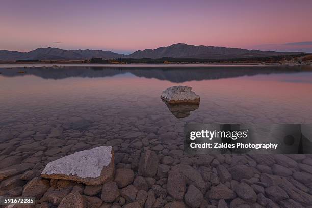 twin rock in the water of lake tekapo - christchurch stock-fotos und bilder