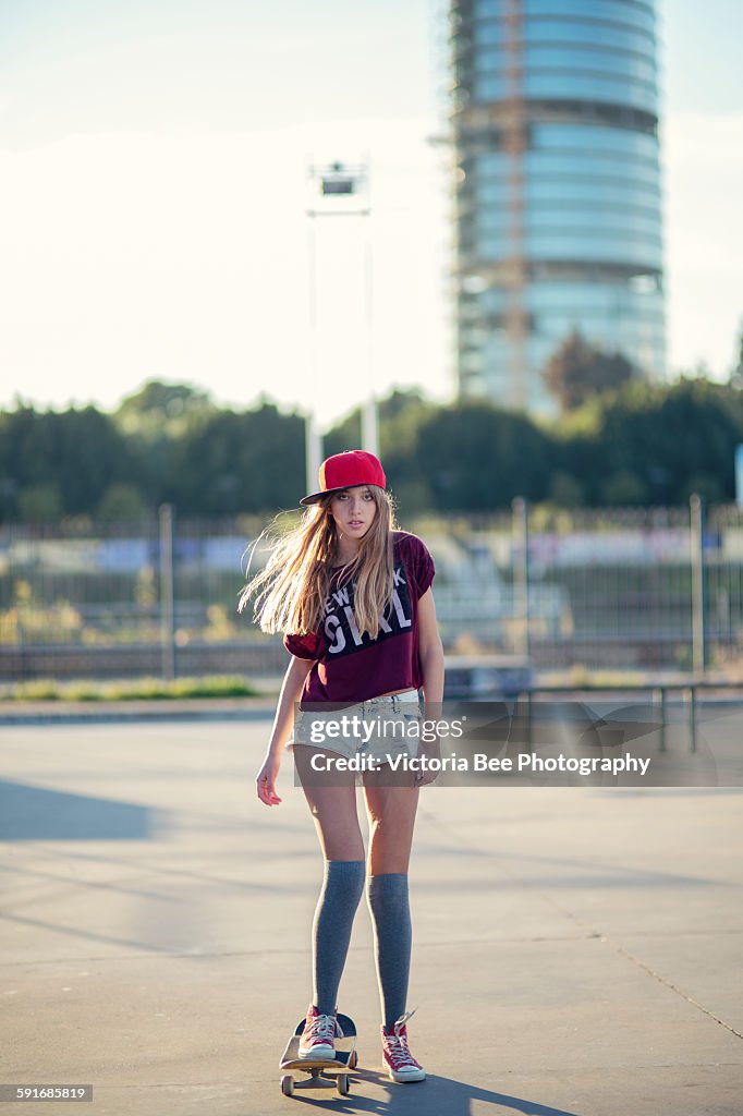 Teenage girl skateboarding