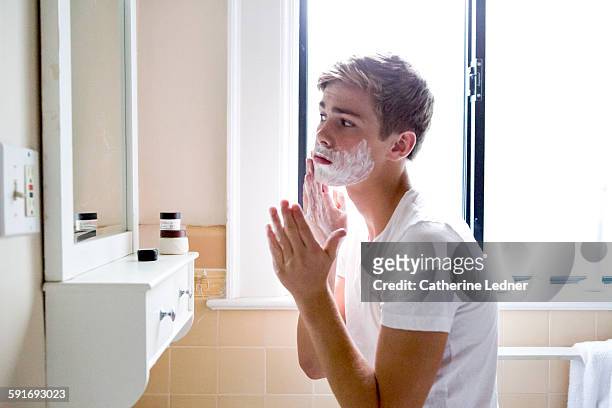 teen age boy shaving - rasieren stock-fotos und bilder