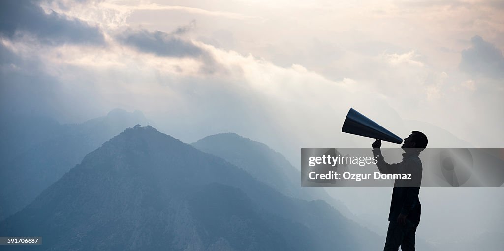 Young man shouting into megaphone