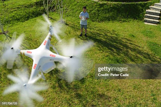 boy playing with drone in garden - drone flying ストックフォトと画像