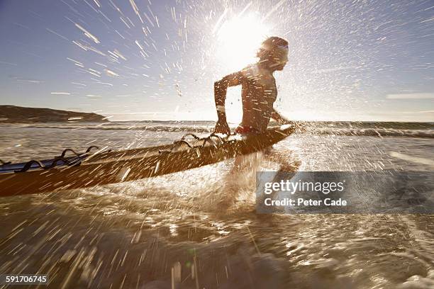 lifeguard running into sea with rescue board - lifesaver stock pictures, royalty-free photos & images