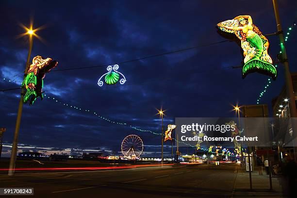 illuminated street decorations & wheel, blackpool. - blackpool stock pictures, royalty-free photos & images