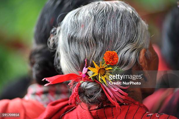 Devotees puts a Blessing flower of idol Bagh Bhairab on her hair during the celebration of Bagh Bhairab festival celebrated at Kirtipur, Kathmandu,...