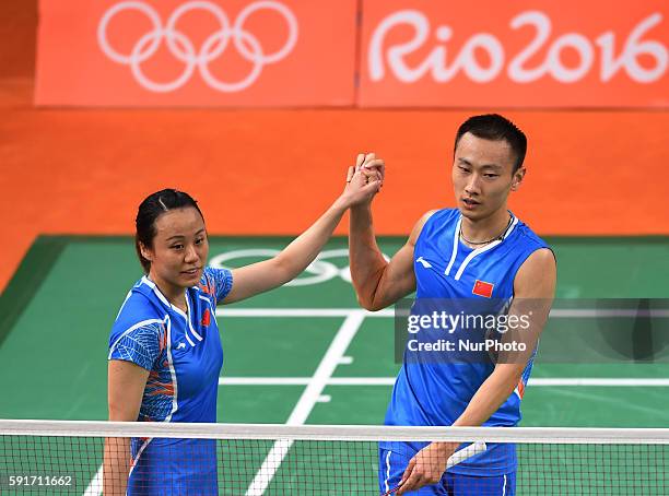 China's Zhang Nan and Zhao Yunlei celebrate after the mixed doubles bronze medal match of Badminton against China's Xu Chen and Ma Jin at the 2016...