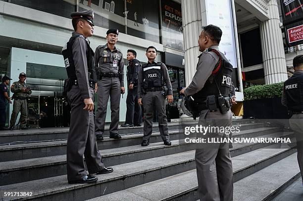 Thai police stand by after disposing of a suspicious bag during a false bomb scare in the tourist-heavy Ratchaprasong district in Bangkok on August...