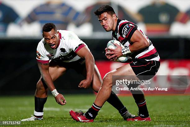 Jonathan Taumateine of Counties Manukau beats the tackle from Tevita Li of North Harbour during the round one Mitre 10 Cup match between North...