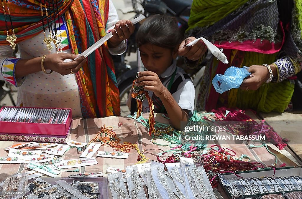 Pakistan Rakhi Api Pakistani Hindu women buy rakhi or sacred thread on the occasion of ...