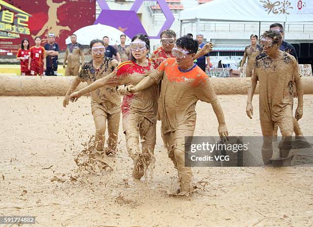 Players battle for a ball in Swamp Soccer World Cup at Yuetan park on August 17, 2016 in Beijing, China. Started on August 13 in Beijing, the 2016...