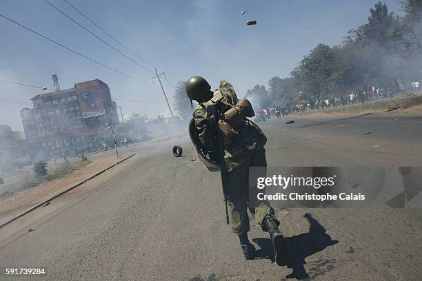 Kenyan policeman fires tear gas at supporters of Ralia Odinga so to prevent them from entering Uhuru Park in central Nairobi, where their political...