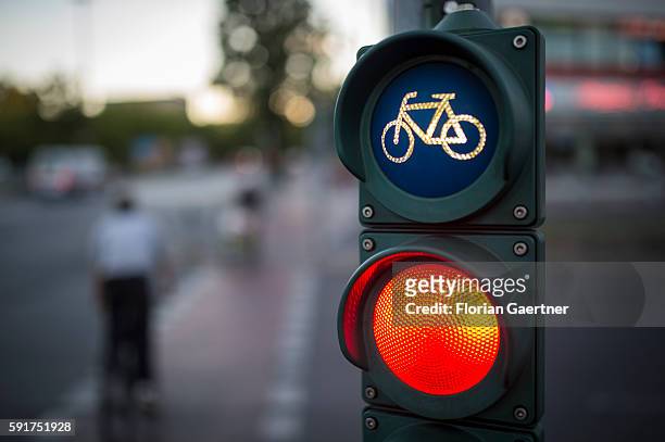 Two cyclists cross the street during traffic lights on August 17, 2016 in Berlin, Germany.