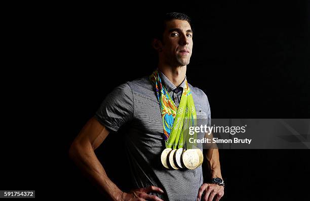 Summer Olympics: Portrait of Team USA swimmer Michael Phelps posing with 5 Gold medals and 1 Silver medal during photo shoot at Main Press Centre in...