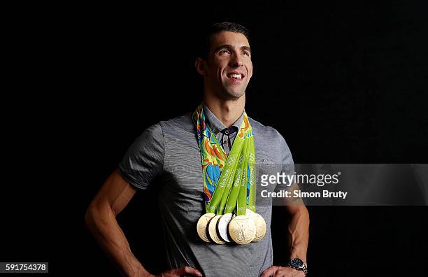 Summer Olympics: Portrait of Team USA swimmer Michael Phelps posing with 5 Gold medals and 1 Silver medal during photo shoot at Main Press Centre in...