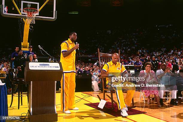 Magic Johnson speaks while Kareem Abdul-Jabbar of the Los Angeles Lakers sits in a big rocking chair before his last game against the Seattle...