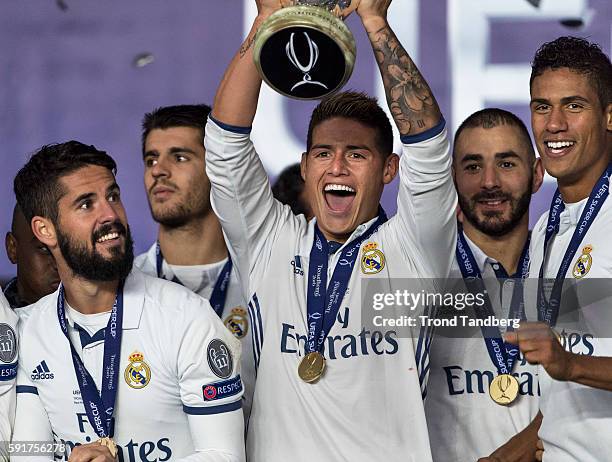 Real Madrid players James Rodriguez, Isco, Alvaro Morata, Karim Benzema, Raphael Varane celebrate with team mates and the trophy after theUEFA Super...