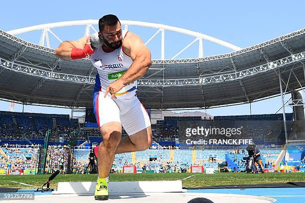Serbia's Asmir Kolasinac competes in the Men's Shot Put Qualifying Round during the athletics event at the Rio 2016 Olympic Games at the Olympic...