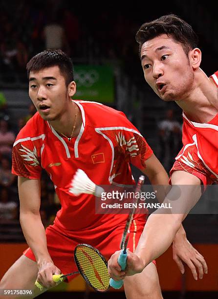 China's Chai Biao and China's Hong Wei returns against Great Britain's Marcus Ellis and Great Britain's Chris Langridge during their men's doubles...