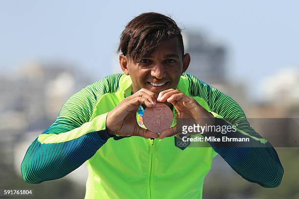 Bronze medalist Isaquias Queiroz dos Santos of Brazil stands on the podium during the medal ceremony for the Men's Canoe Single 200m event at the...