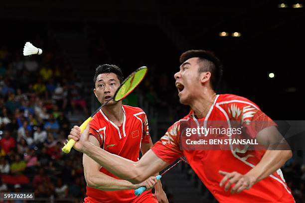 China's Chai Biao and China's Hong Wei returns against Great Britain's Marcus Ellis and Great Britain's Chris Langridge during their men's doubles...
