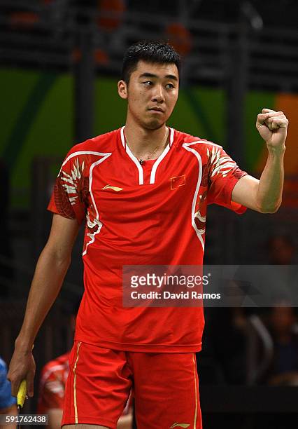 Wei Hong of China celebrates a point against Chris Langridge and Marcus Ellis of Great Britain during the Men's Doubles Badminton Bronze Match on Day...