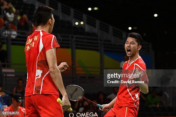 Wei Hong and Biao Chai of China celebrate winning the second set against Chris Langridge and Marcus Ellis of Great Britain during the Men's Doubles...
