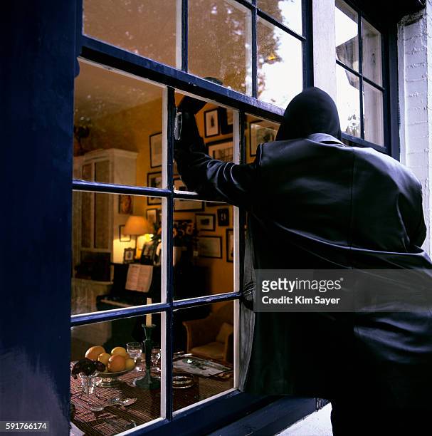burglar smashing through window - rob stock pictures, royalty-free photos & images