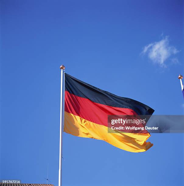 national flag of germany before blue sky - german flag 個照片及圖片檔