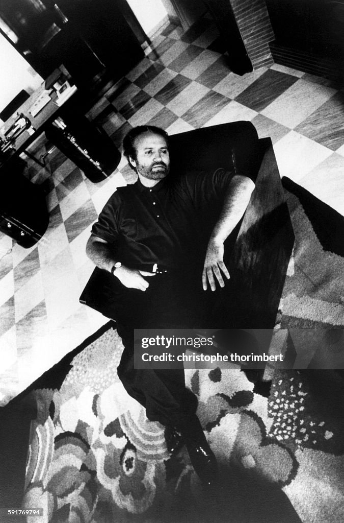 Designer Gianni Versace Sitting in Chair