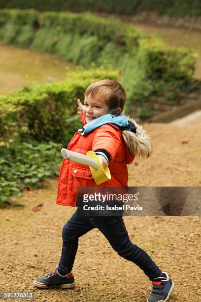 happy boy playing with toy sword in park - bruselas stock pictures, royalty-free photos & images