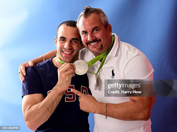 Gymnast, Danell Leyva of the United States poses with his father/coach and his two silver medals on the Today show set on Copacabana Beach on August...