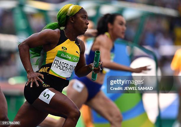 Jamaica's Shelly-Ann Fraser-Pryce competes in the Women's 4 x 100m Relay Round 1 during the athletics event at the Rio 2016 Olympic Games at the...