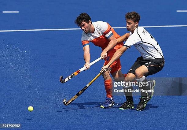 Robert van der Horst of the Netherlands is tackled by Timm Herzbruch during the Men's Bronze Medal match between the etherlands and Germany on Day 13...