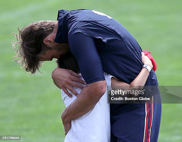 New England Patriots quarterback Tom Brady embraces his son, John Edward Thomas Moynahan, after today's joint practice with the Chicago Bears. The...