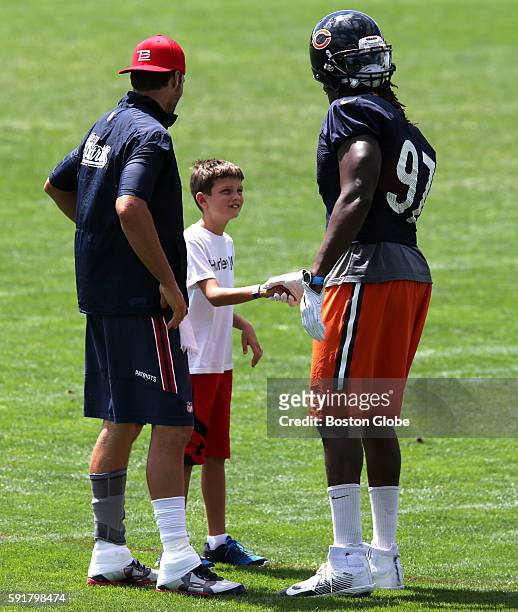 New England Patriots quarterback Tom Brady introduces his son, John Edward Thomas Moynahan, to Chicago Bears outside linebacker Willie Young after...