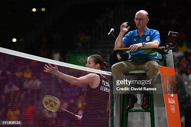 Christinna Pedersen of Denmark questions the umpires decision during the Women's Doubles Badminton Gold Medal Match against Misaki Matsutomo and...