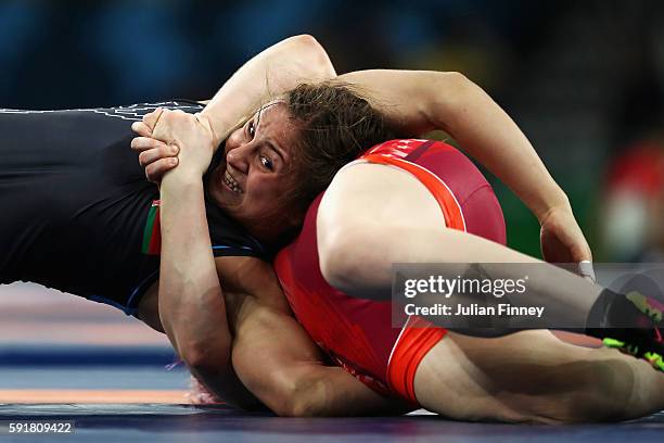 Maryia Mamashuk of Belarus competes against Elena Sergey Pirozhkova of the United States during the Women's Freestyle 63 kg Semifinals match on Day...