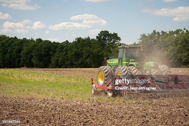 john deere planting crops - harrow agricultural equipment stock pictures, royalty-free photos & images