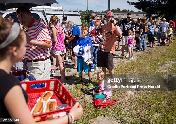 Jordan Roberts, of Biddeford, sells hotdogs to hockey fans waiting in line to see the 2016 Stanley Cup. Brian Dumoulin, a defensemen for the 2016...