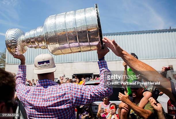 Brian Dumoulin, a defensemen for the 2016 Stanley Cup champions, the Pittsburgh Penguins, carries the Stanley Cup inside of the Biddeford Arena....