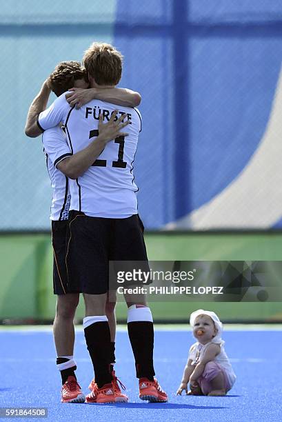 Germany's Moritz Furste celebrates after winning the men's Bronze medal field hockey Netherlands vs Germany match of the Rio 2016 Olympics Games at...
