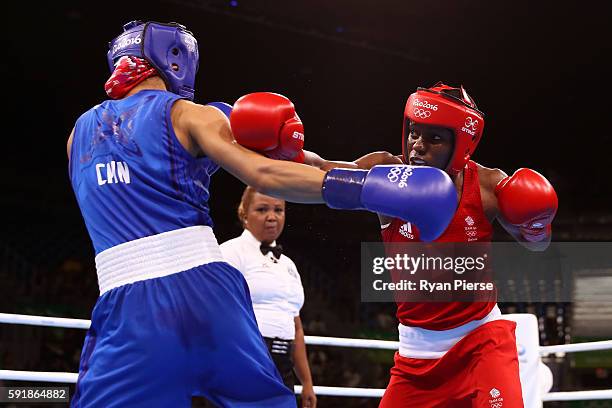 Nicola Adams of Great Britain fights against Cancan Ren of China during a Women's Fly Semifinal bout on Day 13 of the 2016 Rio Olympic Games at...