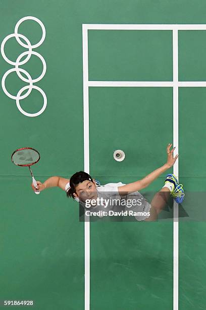 Ayaka Takahashi of Japan plays a shot against Christinna Pedersen and Kamilla Rytter Juhl of Denmark during the Women's Doubles Badminton Gold Medal...