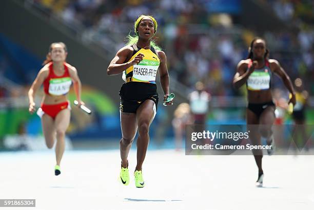 Shelly-Ann Fraser-Pryce of Jamaica leads heat one during round one of the Women's 4 x 100m Relay on Day 13 of the Rio 2016 Olympic Games at the...