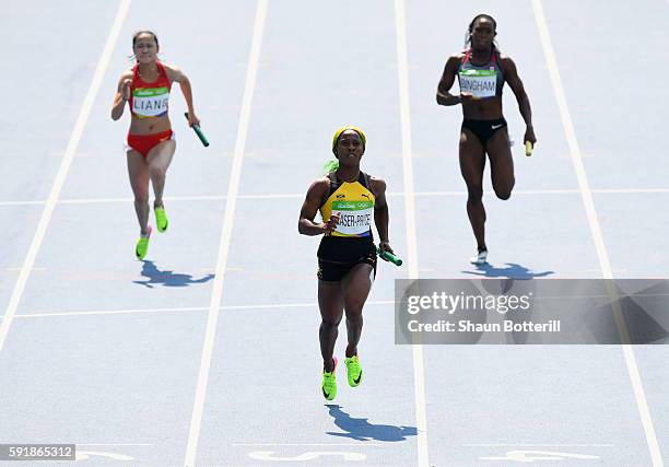 Shelly-Ann Fraser-Pryce of Jamaica leads heat one during round one of the Women's 4 x 100m Relay on Day 13 of the Rio 2016 Olympic Games at the...