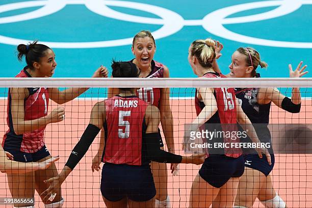 S Jordan Larson-Burbach and teammates celebrate after scoring during the women's semi-final volleyball match between Serbia and USA at the...