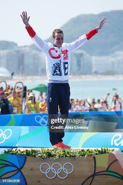 Gold medaltist Alistair Brownlee of Great Britain celebrates on the podium during the Men's Triathlon at Fort Copacabana on Day 13 of the 2016 Rio...