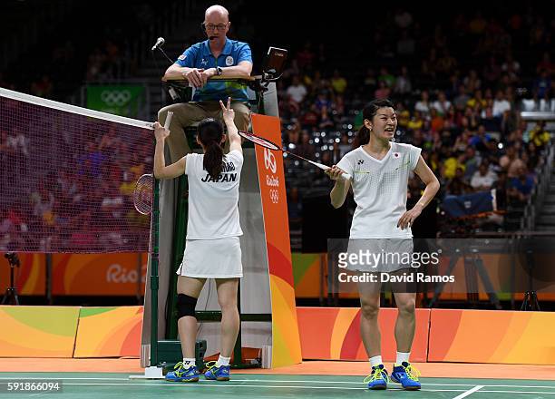 Misaki Matsutomo and Ayaka Takahashi of Japan talk to the umpire during the Women's Doubles Badminton Gold Medal Match against Christinna Pedersen...